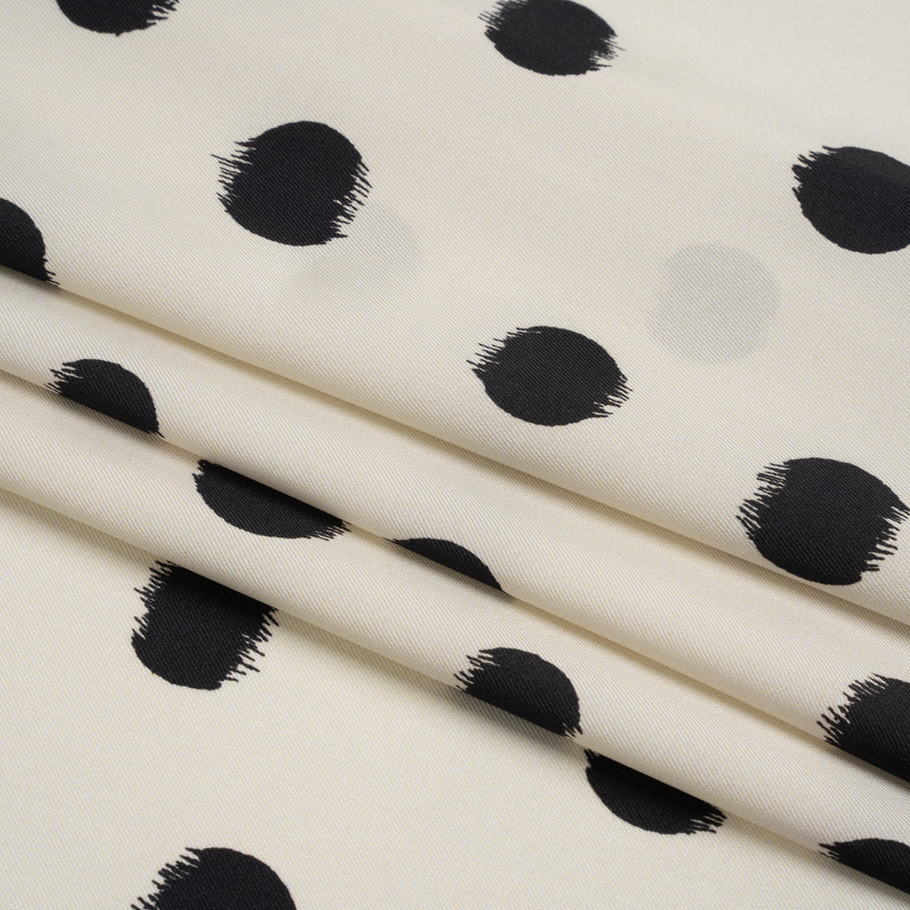 Fabric, polyester twill, black brushed polka dots on ivory background