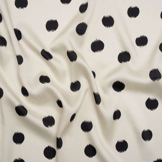 Fabric, polyester twill, black brushed polka dots on ivory background